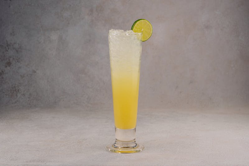 Fresh lemonade in a tall glass with ice
